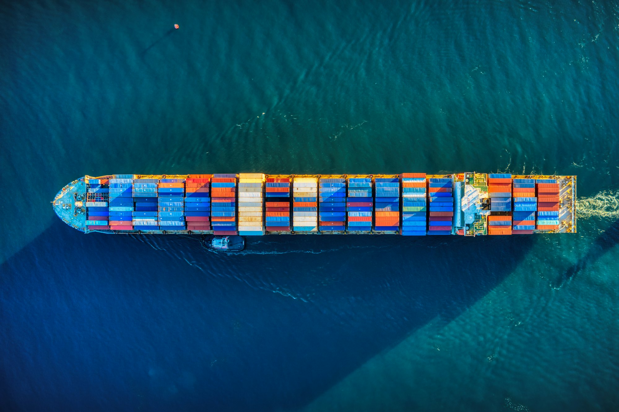 Aerial view of a container ship crossing deep blue water